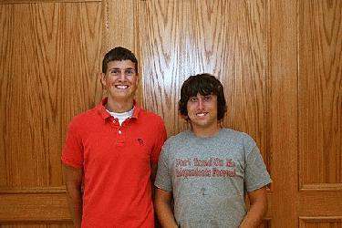 a couple of men standing in front of a wooden door