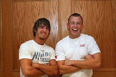 a couple of men smiling