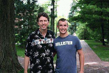 a couple of men standing on a brick path