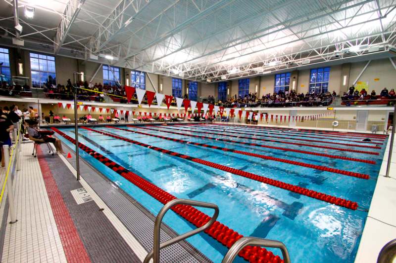 a swimming pool with red and white lanes