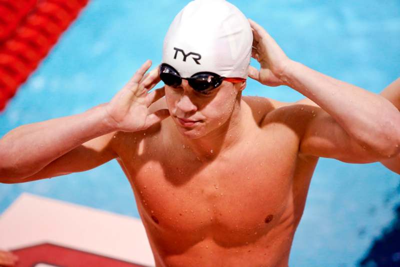a man in a swim cap and goggles