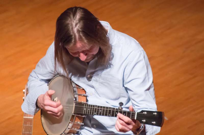 a man playing a banjo
