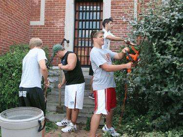 a group of young men working in a yard
