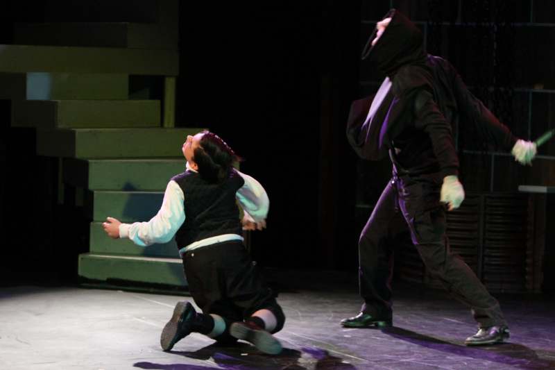 a man in a mask and a woman in a black garment