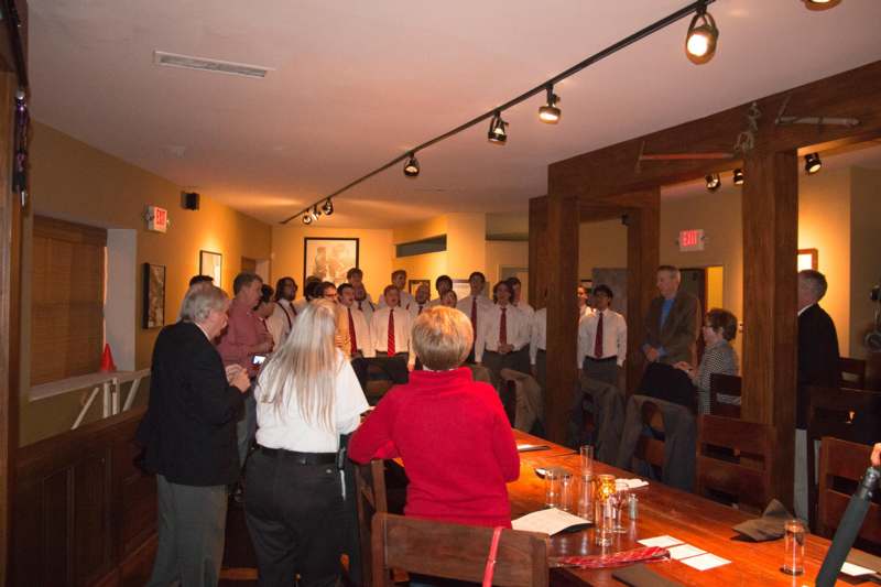 a group of people standing around a table