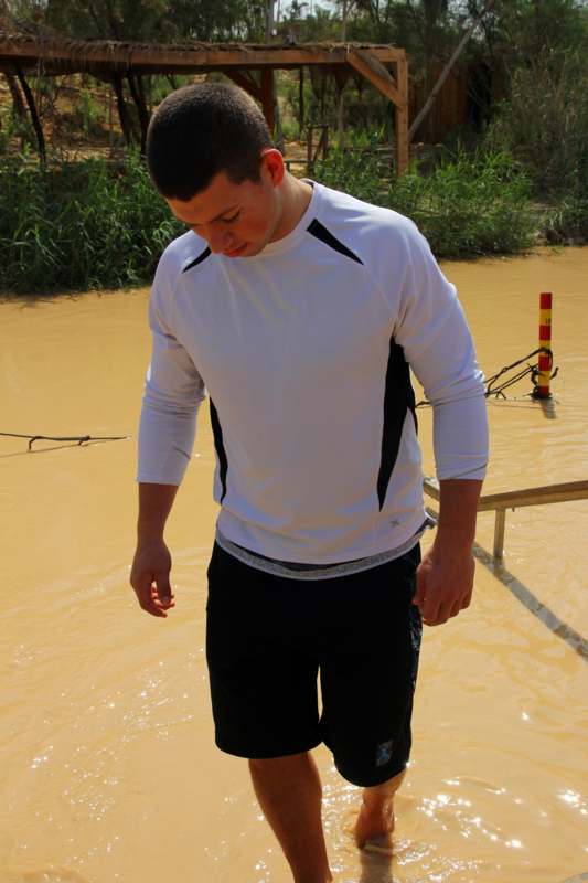 a man standing in a muddy area