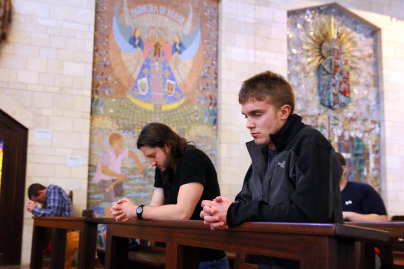 a group of men sitting in a church