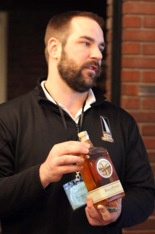a man holding a bottle of alcohol