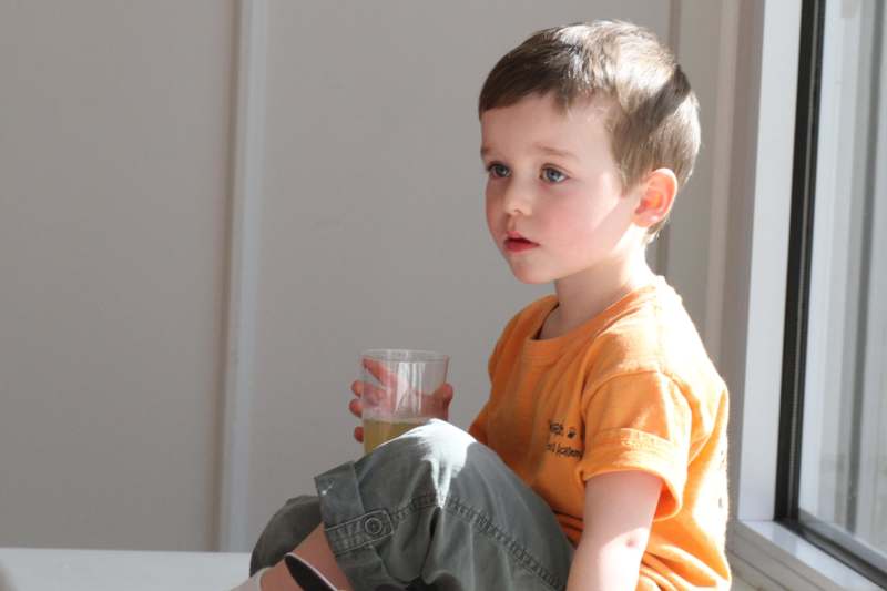 a child holding a glass