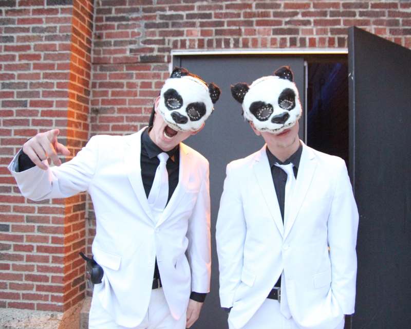 two men wearing white suits and masks