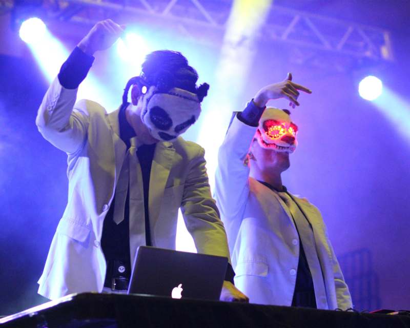 two people wearing masks and dancing