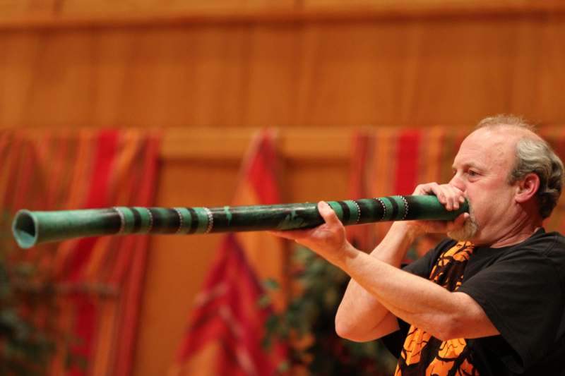 a man playing a green flute