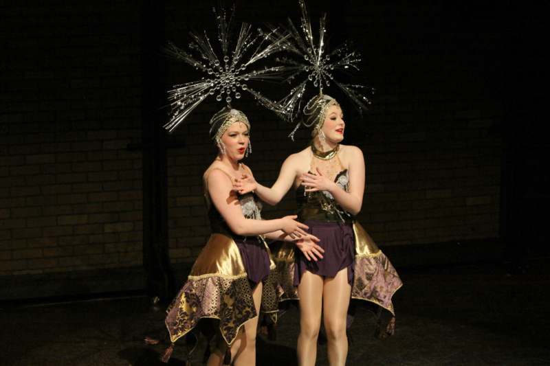 two women wearing clothing on a stage