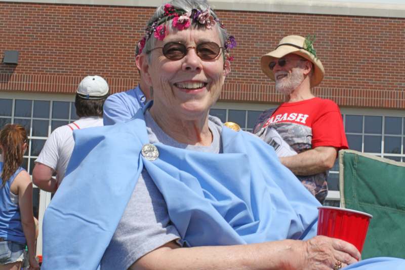 a woman wearing a blue cape and a flower headband