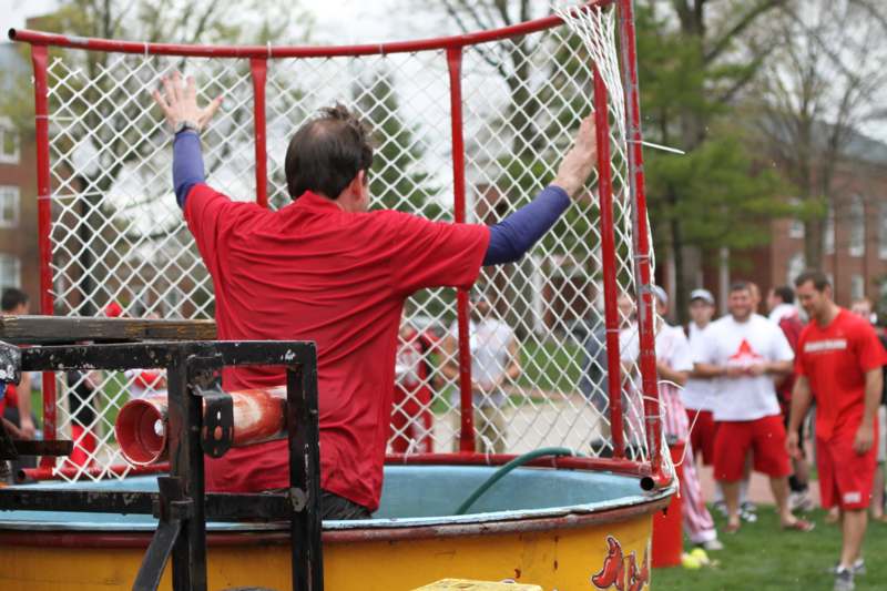 a man in a red shirt reaching into a net