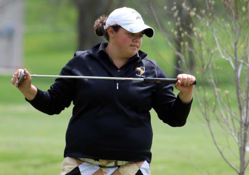 a woman holding a golf club