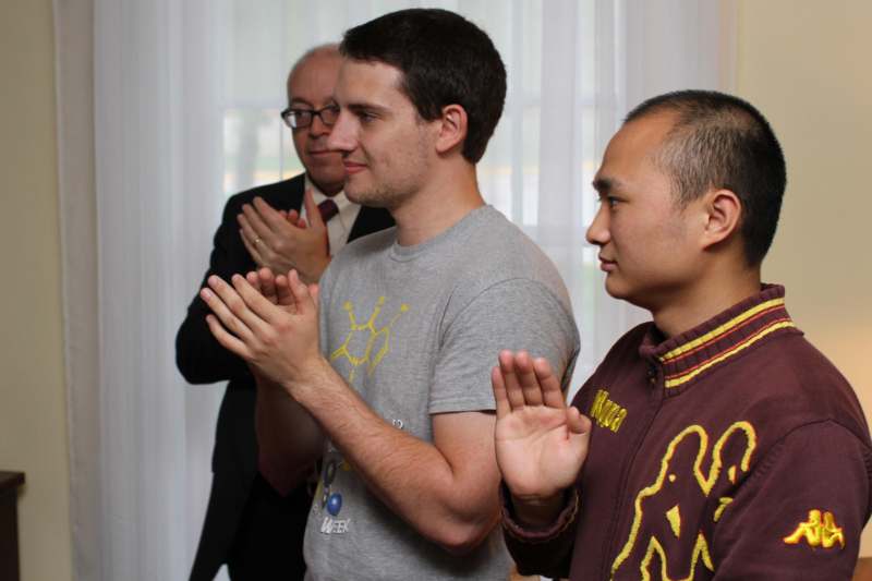 a group of men clapping hands