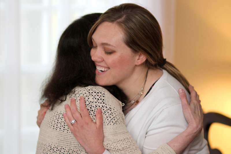 a woman hugging another woman
