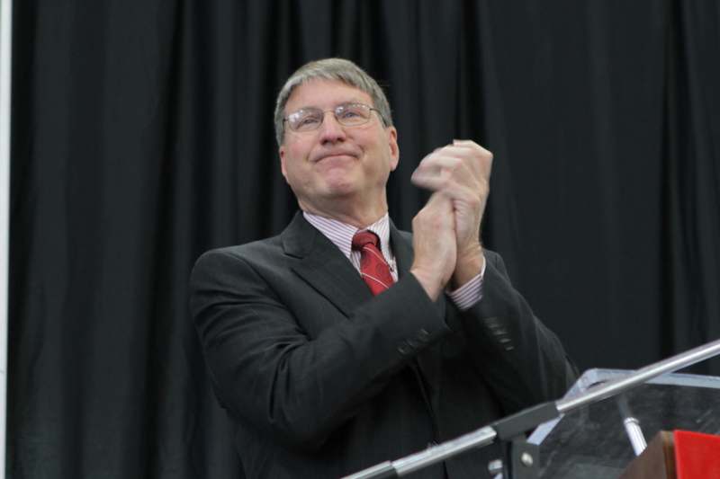 a man in a suit clapping