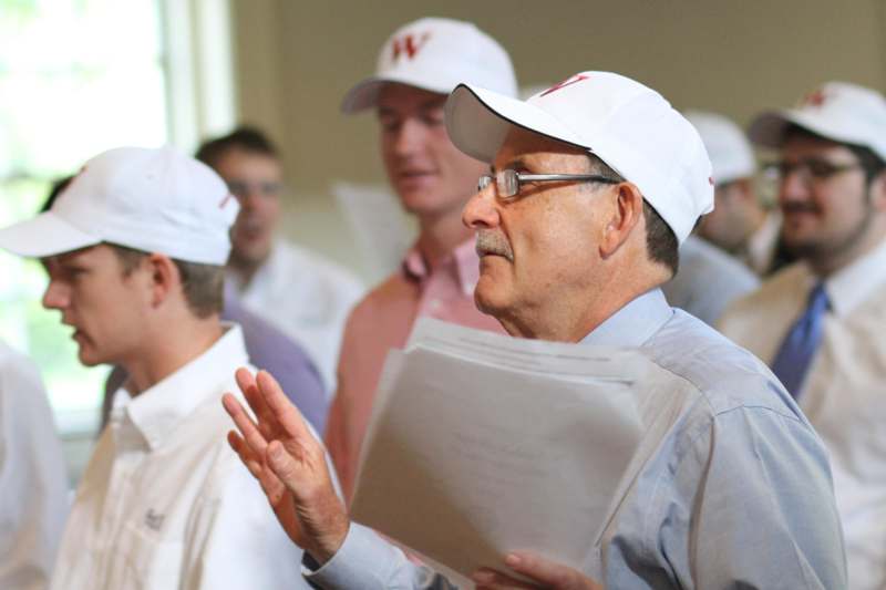 a group of men in white hats