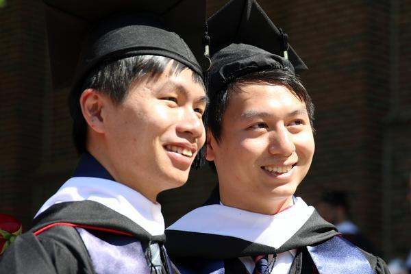 a couple of men in graduation gowns