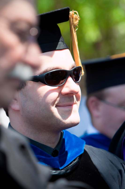 a man wearing a graduation cap and gown