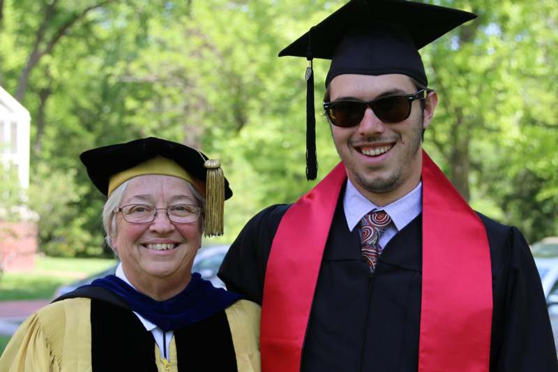 a man and woman in graduation gowns and cap and gown