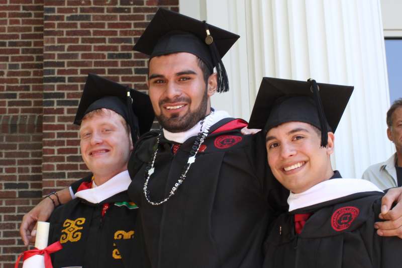 a group of men in graduation gowns