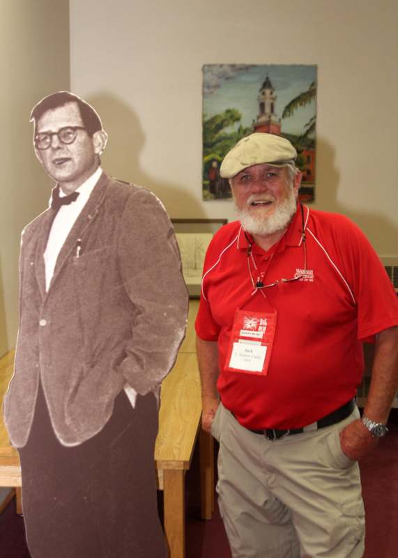 a man standing next to a cutout of a man
