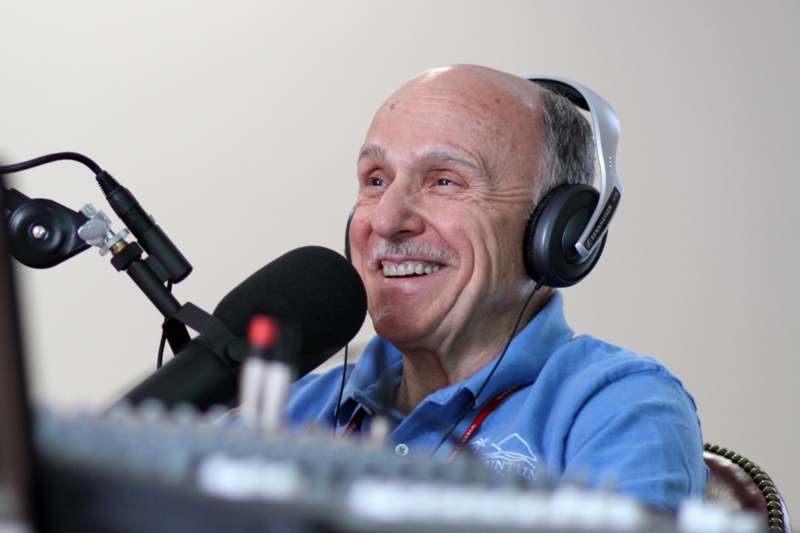 a man wearing headphones and smiling