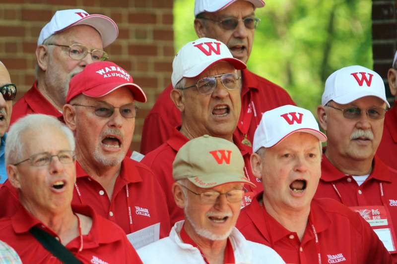 a group of people wearing red shirts and hats