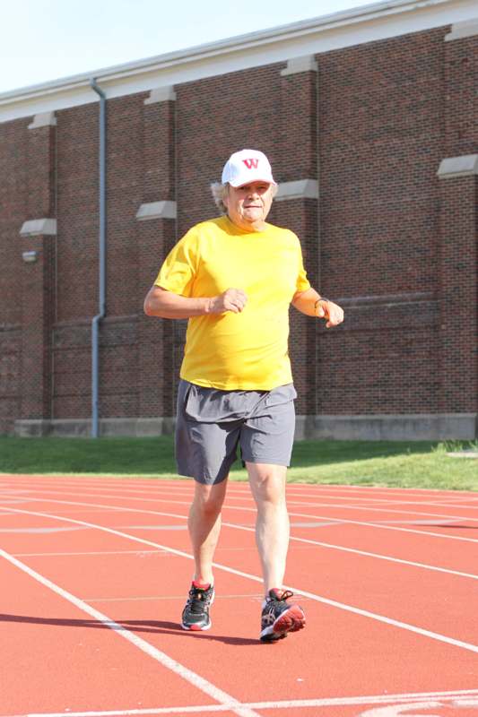 an old man running on a track