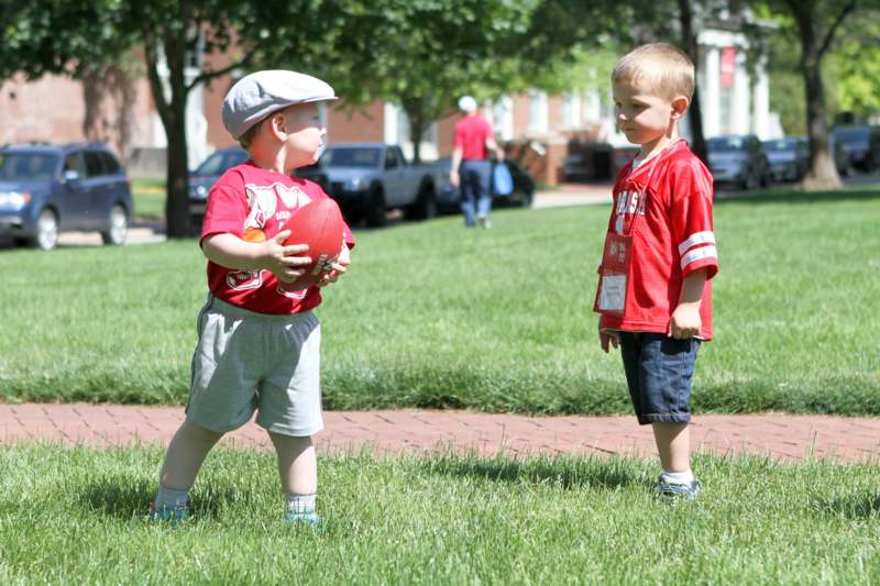 two young boys playing with a football