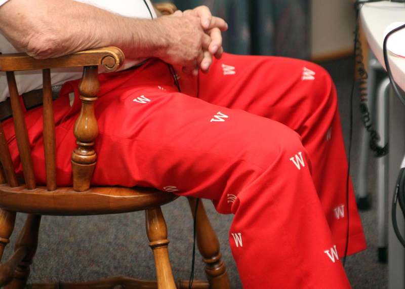 a person wearing red pants with white letters on them