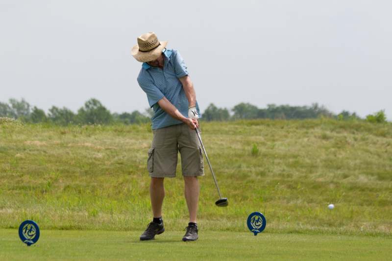 a man playing golf on a field