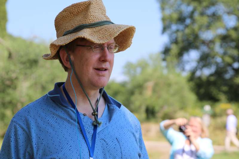 a man wearing a straw hat and lanyard