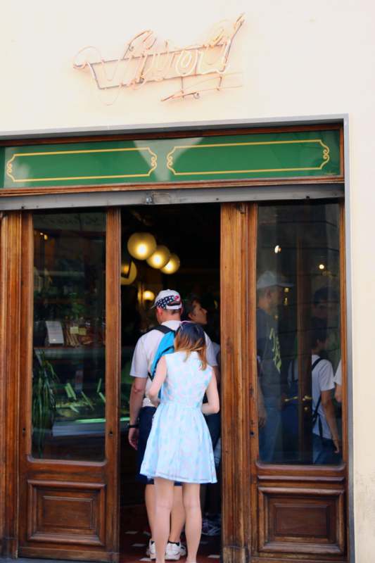 a woman in a dress standing in a doorway of a store