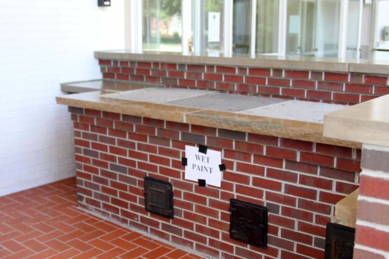 a brick bar with a sign on it
