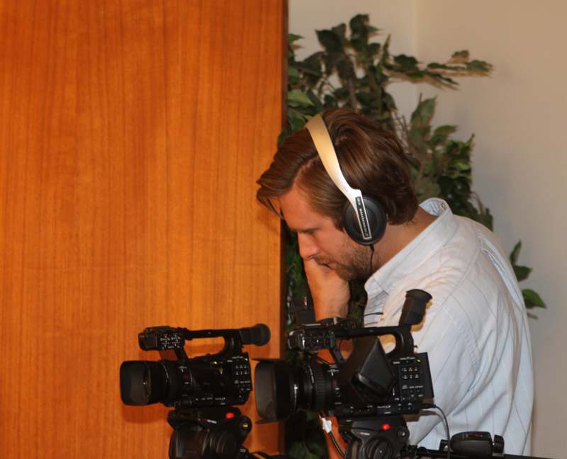 a man wearing headphones and a camera