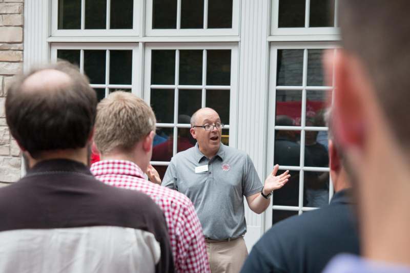 a man speaking to a group of people