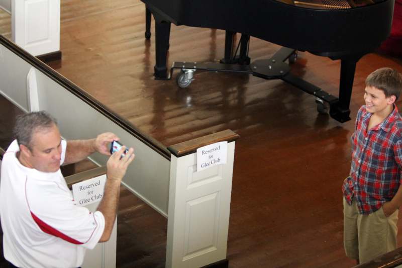 a man taking a picture of a piano