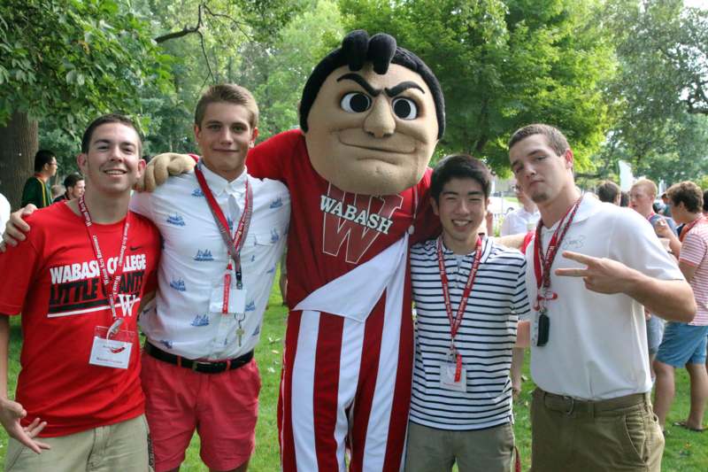 a group of men posing with a mascot