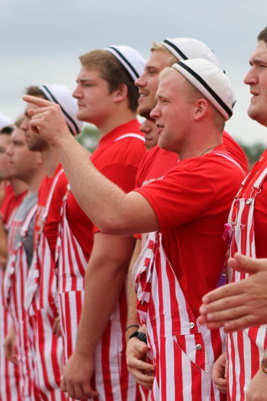 a group of men in red and white striped overalls