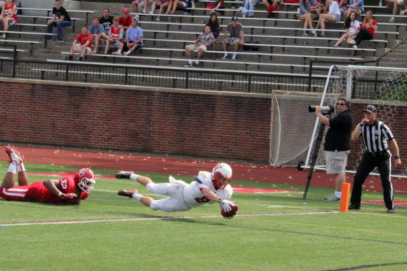a football player diving for a ball
