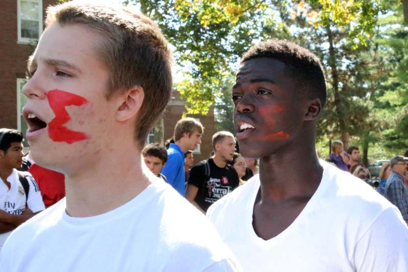 two men with red paint on their faces