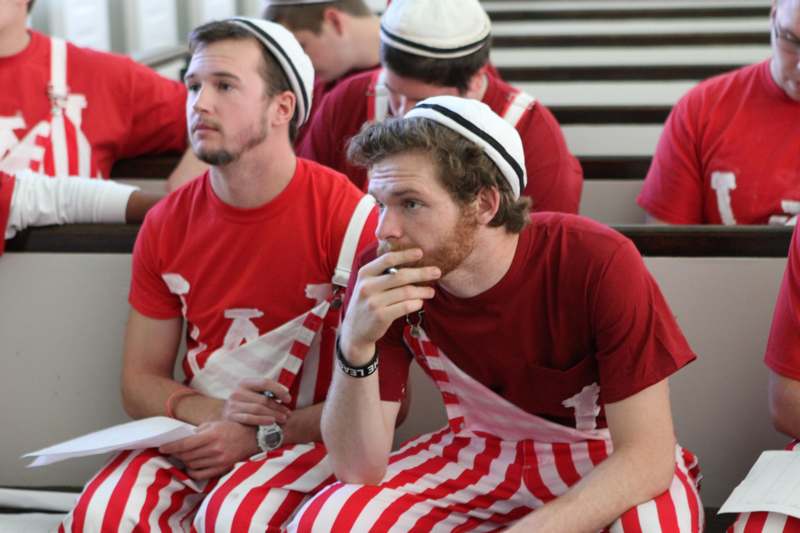 a group of men in red and white striped pants