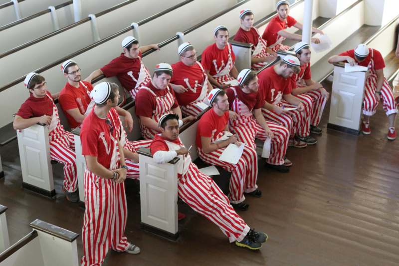 a group of people in striped red and white uniforms