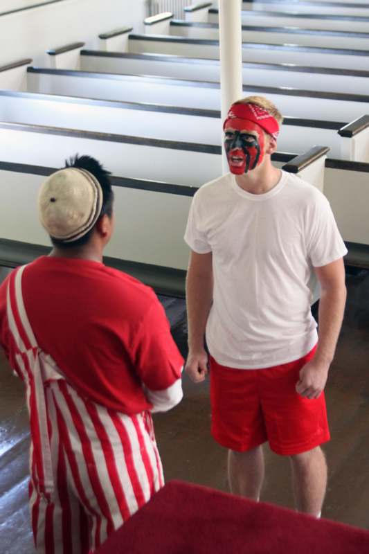 a man with face paint standing next to another man