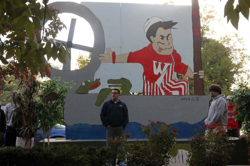 a man standing in front of a mural