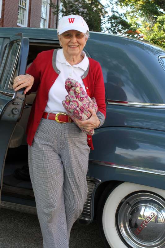 a woman standing in front of a car